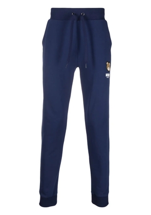 Moschino logo-patch track pants - Blue