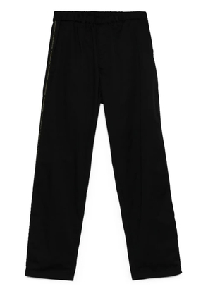 Undercover logo tape-detail trousers - Black
