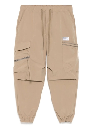 Musium Div. logo-patch trousers - Neutrals