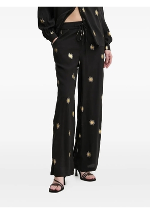 NEVER FULLY DRESSED sun-print trousers - Black