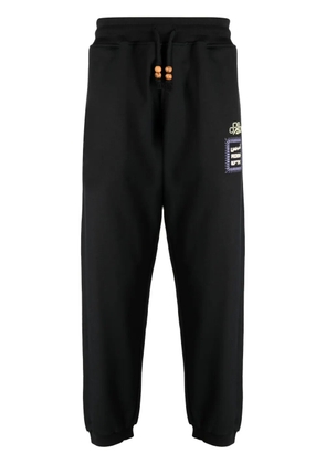 Adish Alkhws logo-print cotton track pants - Black