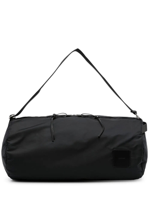 Jil Sander logo-patch circular duffle bag - Black