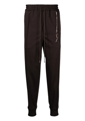 Mastermind World logo-jacquard tapered track pants - Brown