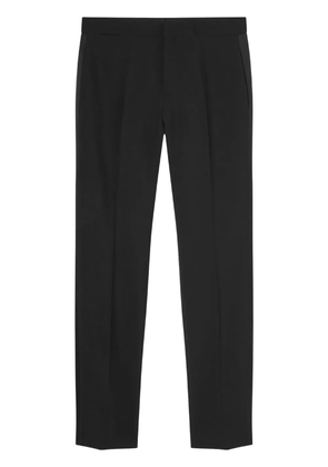 Versace logo-appliqué tapered chino trousers - Black