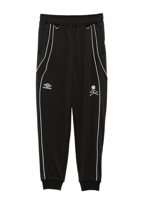 Mastermind World logo-print trousers - Black
