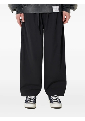 MANASTASH zip-pocket trousers - Black