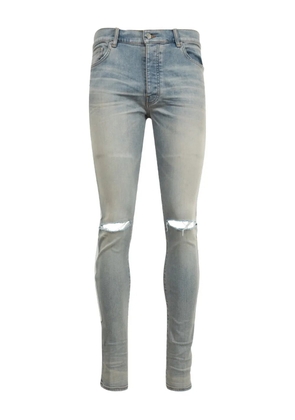 AMIRI Bones-appliqué distressed skinny jeans - Blue