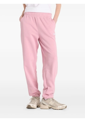 New Balance Sport Essentials fleece track pants - Pink