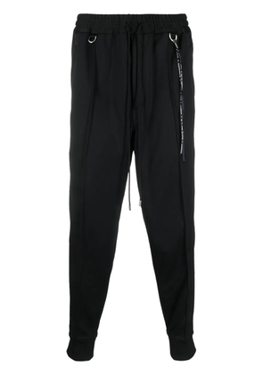 Mastermind Japan skull-tape tapered track pants - Black