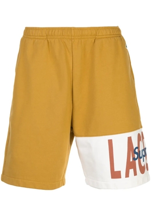 Supreme x Lacoste logo-panel track shorts - Gold