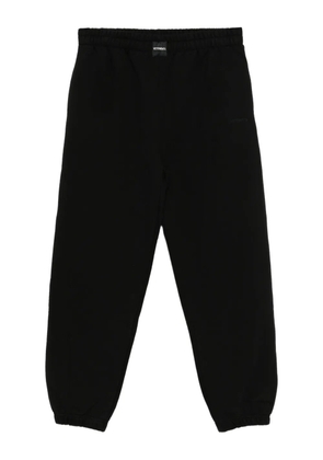 VETEMENTS logo-embroidered trousers - Black