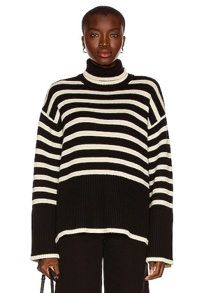 Toteme Signature Stripe Turtleneck Sweater in Black Stripe - Black. Size L (also in M, S).