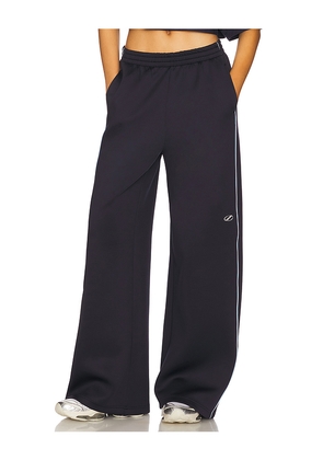 WE11DONE Track Pants in Navy. Size L. Also in S.