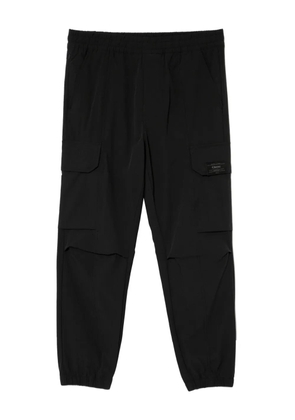CHOCOOLATE logo-patch trousers - Black