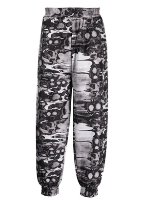 ISO.POETISM Khumbu abstract-print track pants - Black