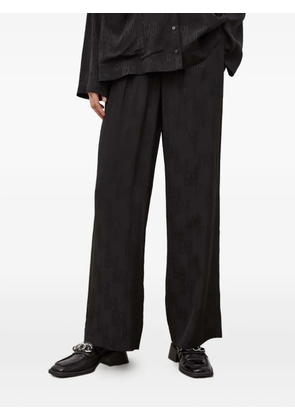 HERSKIND monogram-pattern trousers - Black
