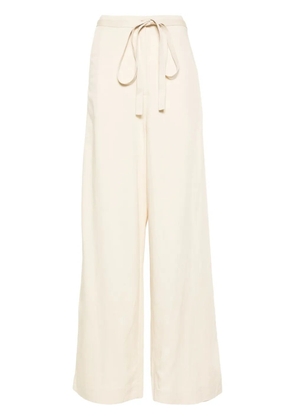 TOTEME belted-waist flared trousers - Neutrals