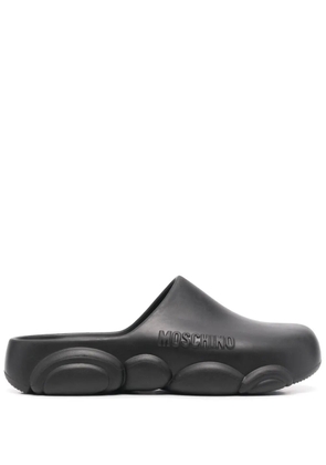 Moschino logo embossed mules - Black