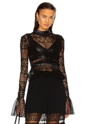 ALAÏA Fitted Long Sleeve Top in Noir - Black. Size 40 (also in ).