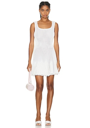 ALAÏA Pleated Mini Dress in Blanc & Ivoire - White. Size 38 (also in ).