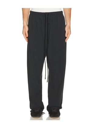Fear of God ESSENTIALS Relaxed Track Pant in Black. Size L. Also in M, S, XL/1X, XS, XXL/2X.