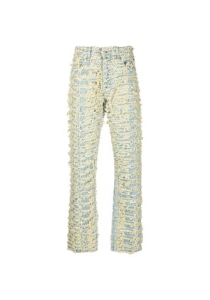 Who Decides War distressed logo-patch jeans - Yellow