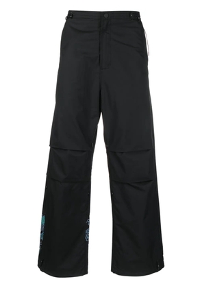 Maharishi graphic-print trousers - Black