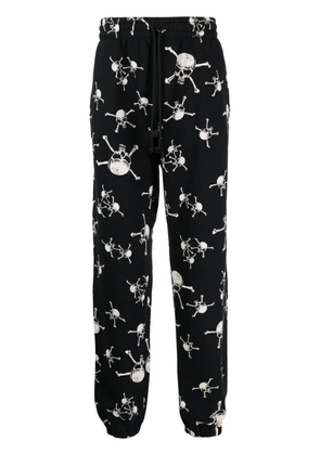 SAINT MXXXXXX skull-print cotton track pants - Black