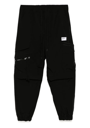 Musium Div. logo-patch trousers - Black