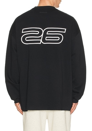 Fear of God ESSENTIALS 90'S Long Sleeve Tee in Vintage Black - Black. Size L (also in M, S, XL/1X, XS, XXL/2X).