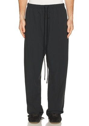 Fear of God ESSENTIALS Relaxed Track Pant in Vintage Black - Black. Size L (also in M, S, XL/1X, XS, XXL/2X).