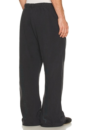 Fear of God ESSENTIALS Flare Sweatpant in Vintage Black - Black. Size L (also in M, S, XL/1X, XS, XXL/2X).
