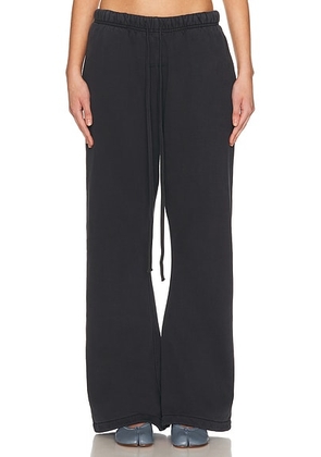 Fear of God ESSENTIALS Flare Sweatpant in Vintage Black - Black. Size L (also in M, S, XL, XS).
