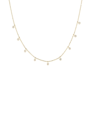 STONE AND STRAND Teeny Dangling Diamond Bead Chain Necklace in Metallic Gold.