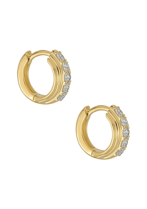 STONE AND STRAND Dainty Boulevard Huggie Earrings in Metallic Gold.