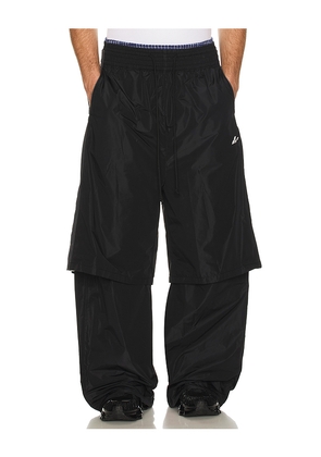 WE11DONE Triple Layered Track Pants in Black. Size L. Also in S, M, XL/1X.