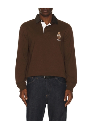 Polo Ralph Lauren Long-sleeve Jersey Knit Novelty Bear Rugby Polo W/ Cord Collar in Brown. Size L. Also in M, S, XL/1X, XS, XXL/2X.