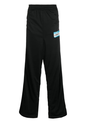 VETEMENTS logo-print wide-leg trousers - Black