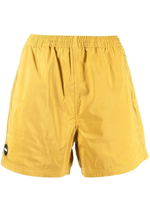 Pleasures embossed logo bermuda shorts - Yellow