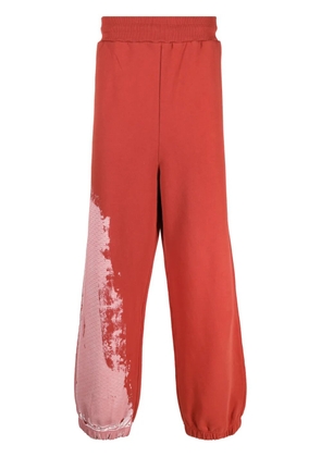 A-COLD-WALL* tie-dye pattern track pants - Red