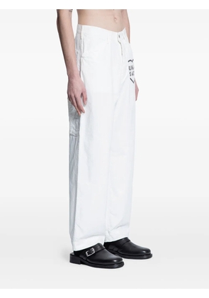 Human Made logo-motif duck-print trousers - White