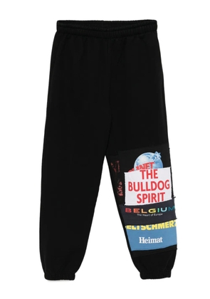 VETEMENTS graphic-print trousers - Black