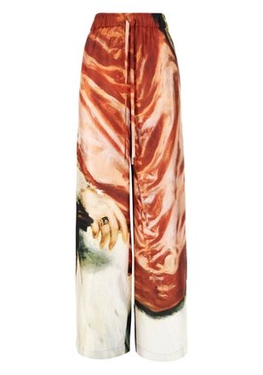 Alexander McQueen all-over printed trousers - Red