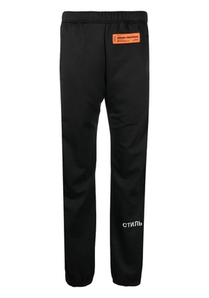 Heron Preston logo patch ruched-ankle trousers - Black