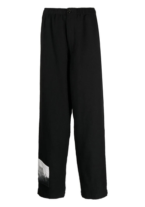 Undercover graphic-patch wool trousers - Black