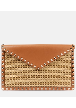 Valentino Garavani Rockstud Large leather-trimmed raffia clutch