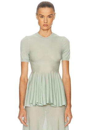 ALAÃA Peplum Top in Vert Amande - Sage. Size 38 (also in 34, 40).