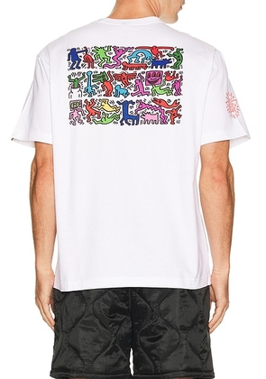 ALPHA INDUSTRIES x Keith Haring Graphic Tee in White - White. Size L (also in S, XL/1X, XXL/2X).