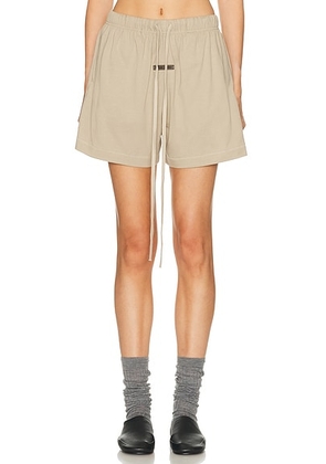 Fear of God ESSENTIALS Soccer Short in Timber - Beige. Size M (also in XS, S, L).