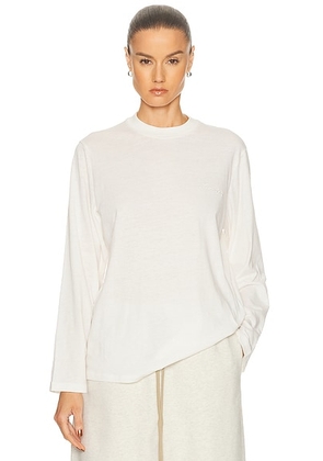 Fear of God ESSENTIALS Classic Fit Long Sleeve Tee in Ivory - Ivory. Size M (also in XXS, XS, S, L).